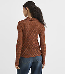 A woman in a textured brown collared shirt and blue jeans stands against a plain white background. carousel Product Image 3