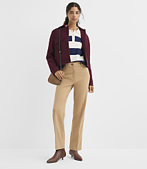A woman in a maroon jacket, striped shirt, and tan pants stands against a plain white background. carousel Product Image 1