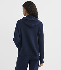 A woman in a navy blue hoodie and pants stands against a plain white background. carousel Product Image 3