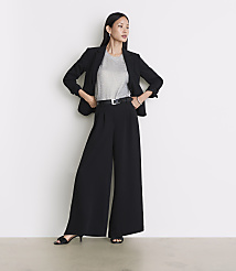 A woman in a black blazer and wide-leg pants stands against a plain white background. carousel Product Image 1