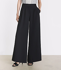 A person stands in black wide-leg pants and sandals against a plain white background. carousel Product Image 2