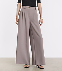 A person stands in wide-leg taupe pants and black heels against a plain white background. carousel Product Image 2