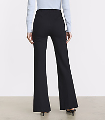 A person wearing black flared pants and a light blue sweater stands against a plain, light-colored background. carousel Product Image 3