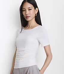 A woman in a white ruched t-shirt and striped pants stands against a plain white background. carousel Product Image 2