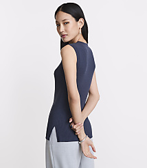 A woman in a navy blue sleeveless top and light blue pants stands against a plain white background. carousel Product Image 3