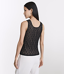 A woman in a black lace tank top and white pants stands against a plain white background. carousel Product Image 3