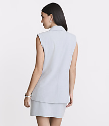 A woman in a light gray sleeveless blazer and skirt stands against a plain white background. carousel Product Image 3