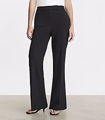 A person stands in black flared pants and a white top against a plain white background. carousel Product Image 2