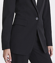 A close-up of a person wearing a black blazer and pants against a plain white background. carousel Product Image 4