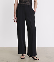 A person stands in black wide-leg trousers and sandals against a plain white background. carousel Product Image 2