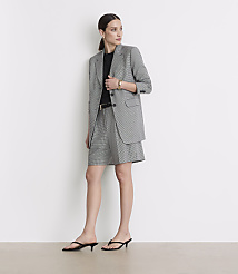 A woman in a black and white checkered blazer and shorts stands against a plain white background. carousel Product Image 1