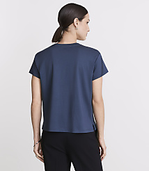 A woman in a blue t-shirt and black pants stands against a plain white background. carousel Product Image 3