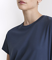 A close-up of a woman's shoulder and neck wearing a dark blue t-shirt against a plain white background. carousel Product Image 4