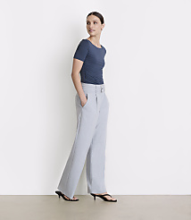 A woman in a blue ruched top and light gray wide-leg pants stands against a plain white background. carousel Product Image 1