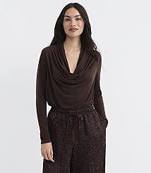A woman in a brown cowl-neck top and leopard-print pants stands against a plain white background. carousel Product Image 1