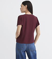 A woman in a maroon blouse and blue jeans stands against a plain white background. carousel Product Image 3