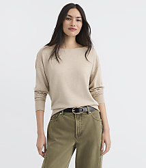 A woman in a beige sweater and green pants stands against a plain white background. carousel Product Image 1