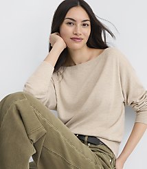 A woman in a beige sweater and green pants poses against a plain white background. carousel Product Image 2