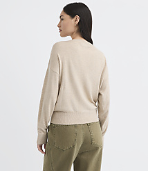 A woman in a beige sweater and olive green pants stands against a plain white background. carousel Product Image 3