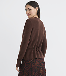 A woman in a brown cardigan and leopard print skirt stands against a plain brown background. carousel Product Image 3