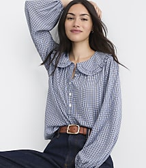 A woman in a blue gingham blouse and brown belt poses against a plain white background. carousel Product Image 1