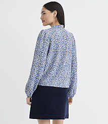 A woman in a blue floral blouse and navy skirt stands against a plain white background. carousel Product Image 3