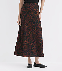 A woman in a leopard print skirt and black flats stands against a plain white background. carousel Product Image 2