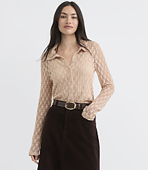 A woman in a sheer, patterned blouse and a dark skirt stands against a plain, light background. carousel Product Image 1