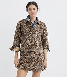 A woman in a leopard-print jacket and skirt stands against a plain white background. carousel Product Image 1