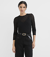 A woman in a black lace top and black pants with a gold-buckled belt stands against a plain white background. carousel Product Image 2