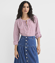 A woman in a striped blouse and denim skirt stands against a plain white background. carousel Product Image 1