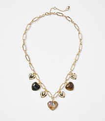 A gold chain necklace with multiple heart-shaped charms, some metallic and others iridescent, rests against a plain white background. carousel Product Image 1