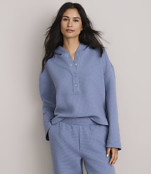 A woman in a blue waffle-knit hoodie and matching shorts stands against a plain gray background. carousel Product Image 2