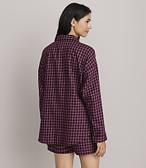 A woman in a burgundy plaid pajama set stands against a plain, light gray background. carousel Product Image 3