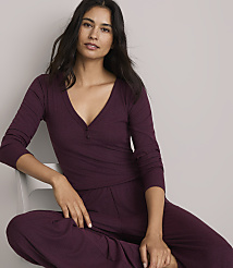 A woman in a burgundy henley and matching pants sits against a plain, light gray background. carousel Product Image 2