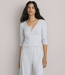 A woman in a grey pajama set stands against a plain, light grey background. carousel Product Image 1