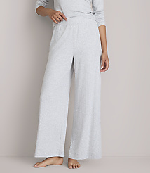 A person stands in light gray wide-leg pajamas against a plain gray background. carousel Product Image 2