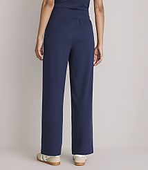 A person wearing navy blue pajama pants and sneakers stands against a plain gray background. carousel Product Image 3