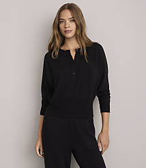 A woman in a black henley shirt and pants stands against a plain white background. carousel Product Image 2
