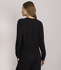 A woman in a black long-sleeved shirt and pants stands against a plain gray background. carousel Product Image 3