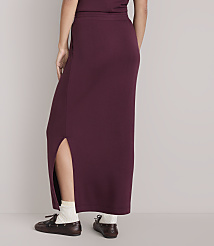 A person wearing a maroon maxi skirt with a side slit and white socks stands in front of a plain white background. carousel Product Image 3