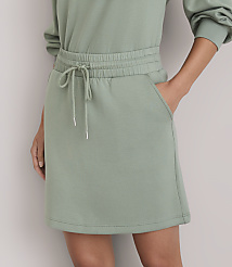 A light green sweatshirt dress with a drawstring waist and pockets is shown against a plain white background. carousel Product Image 2