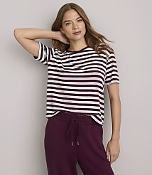 A woman in a striped t-shirt and maroon sweatpants poses against a plain gray background. carousel Product Image 1