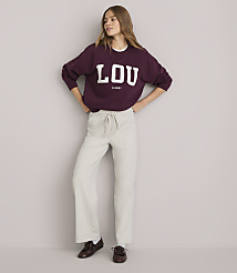 A young woman in a maroon sweatshirt and light-colored pants stands against a plain white background. carousel Product Image 2
