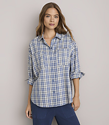 A woman in a blue plaid shirt stands against a plain gray background. carousel Product Image 2