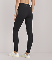 A person wearing black leggings and white sneakers stands against a plain white background. carousel Product Image 3