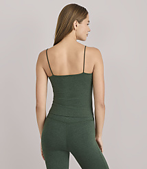 A woman in a green tank top and leggings stands against a plain gray background. carousel Product Image 4