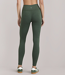 A woman wearing green heathered leggings and white-and-green sneakers stands against a plain white background. carousel Product Image 4