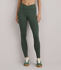 A person wearing green heathered leggings and green sneakers stands against a plain white background. carousel Product Image 3
