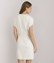 A woman in a cream-colored dress stands against a plain white background. carousel Product Image 3